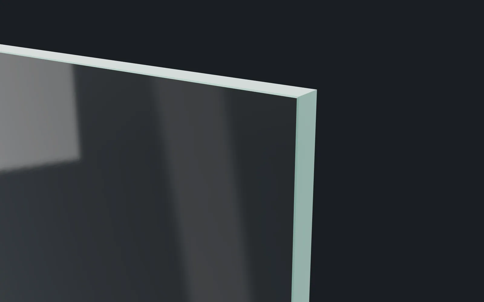 Corner of a 1/2 inch clear tempered glass panel, its polished edge lit against a dark studio